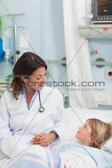 Doctor holding the hand of a child