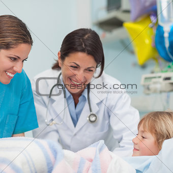 Doctor and nurse smiling to a child