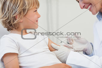 Doctor giving to a child an injection