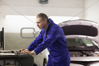 Mechanic looking at a computer