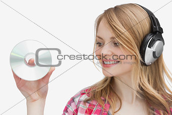 Woman holding a cd while looking it