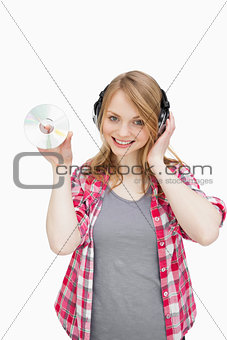 Woman standing while holding a cd