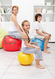Happy family exercising at home