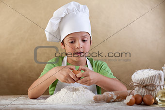 Little chef preparing the dough for cookies