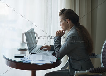 Thoughtful business woman working in hotel room