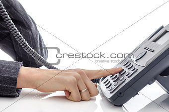 Female hand dialing a phone number