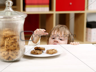 Little boy stealing cookies