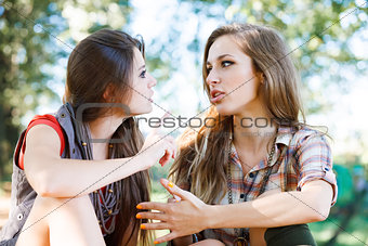 two girlfriends outdoor talking