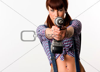Beautiful Brunette points a cordless drill pausing to play