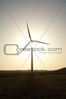 wind turbine against sun