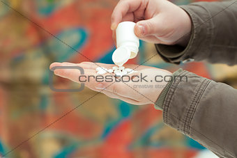 Drugs in the hands on a wall background