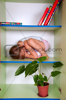 little girl hugging a toy and hiding in a closet