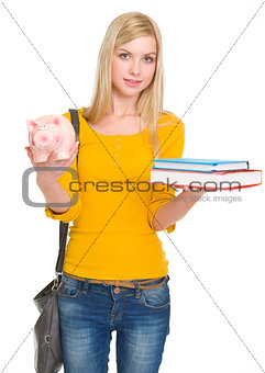 Student girl showing books and piggy bank