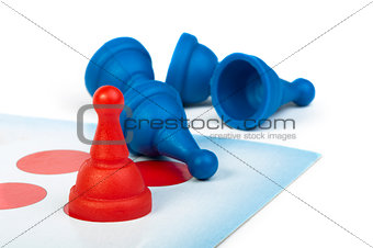 Red and blue game pawns white isolated
