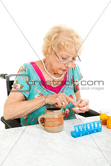 Disabled Senior Examining Her Medication