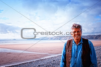 A mature man standing on Newgale  beach