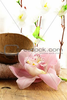 spa concept - pink orchid on a wooden background
