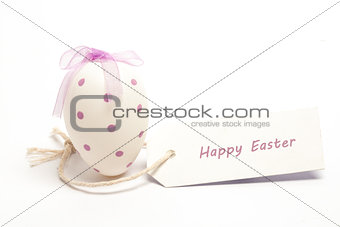 Easter egg with tag spelling out Happy easter