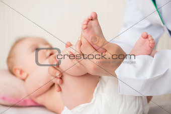 Doctor massaging  baby