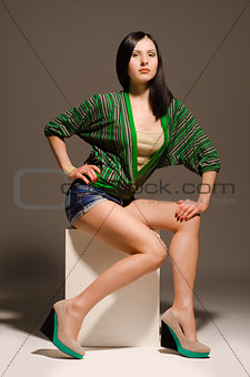 Beautiful sexy young woman posing sitting