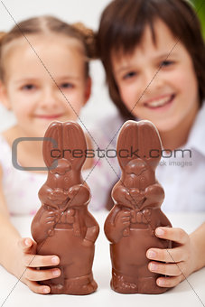 Happy easter kids with large chocolate bunnies