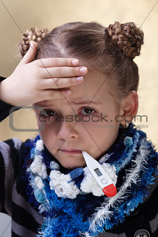 Little girl with the flu checking her temperature