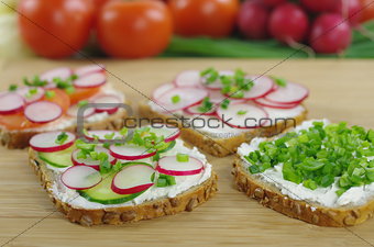 four slices of bread with cottage cheese and the vegetables