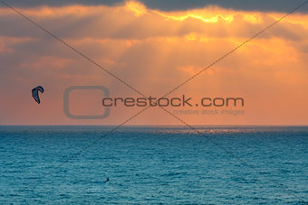 Kitesurfer on Mediterranean sea at sunset in Israel.