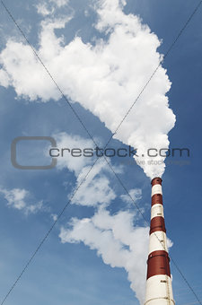 industrial smoke from chimney on blue sky 