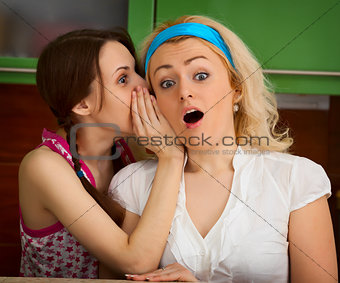 Girls gossiping in the kitchen