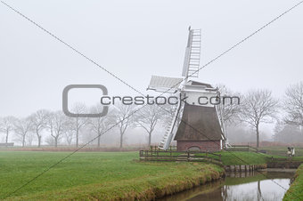 Dutch windmill in fog