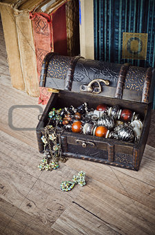  casket with jewelry and old book on a wooden surface 