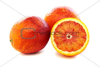 Full and half of blood red oranges.