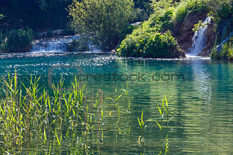 summer waterfalls and green  limpid lake