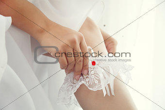 Bride dress up a white garter