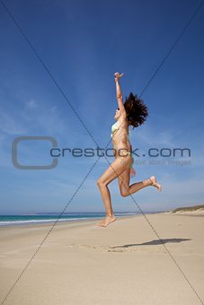 bikini woman jumping at beach