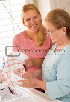 Senior Adult Woman and Young Daughter Talking in Kitchen