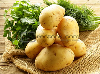 fresh organic potatoes on a wooden table