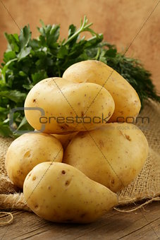 fresh organic potatoes on a wooden table