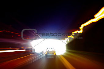 Car exiting a dark tunnel