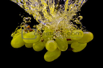Grapes in water splash isolated on black background