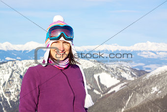 Smiling girl in snowy mountains