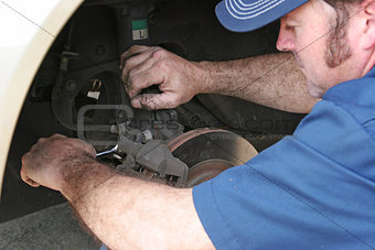 Auto Mechanic Works on Brakes