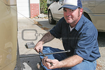Mechanic Using Tire Iron