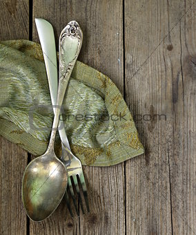 vintage silver cutlery  on a wooden background