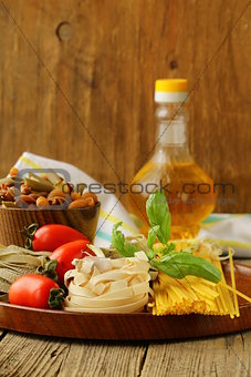 Various types of pasta (spaghetti, fettuccini, penne) and tomato