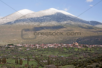 Village And Snow-Capped Mountain