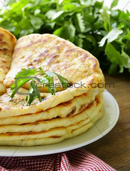 pile of fried bread with butter and parsley
