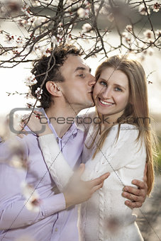 Young romantic couple in spring blossom