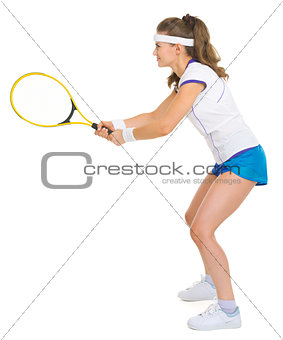 Confident female tennis player in stance . side view